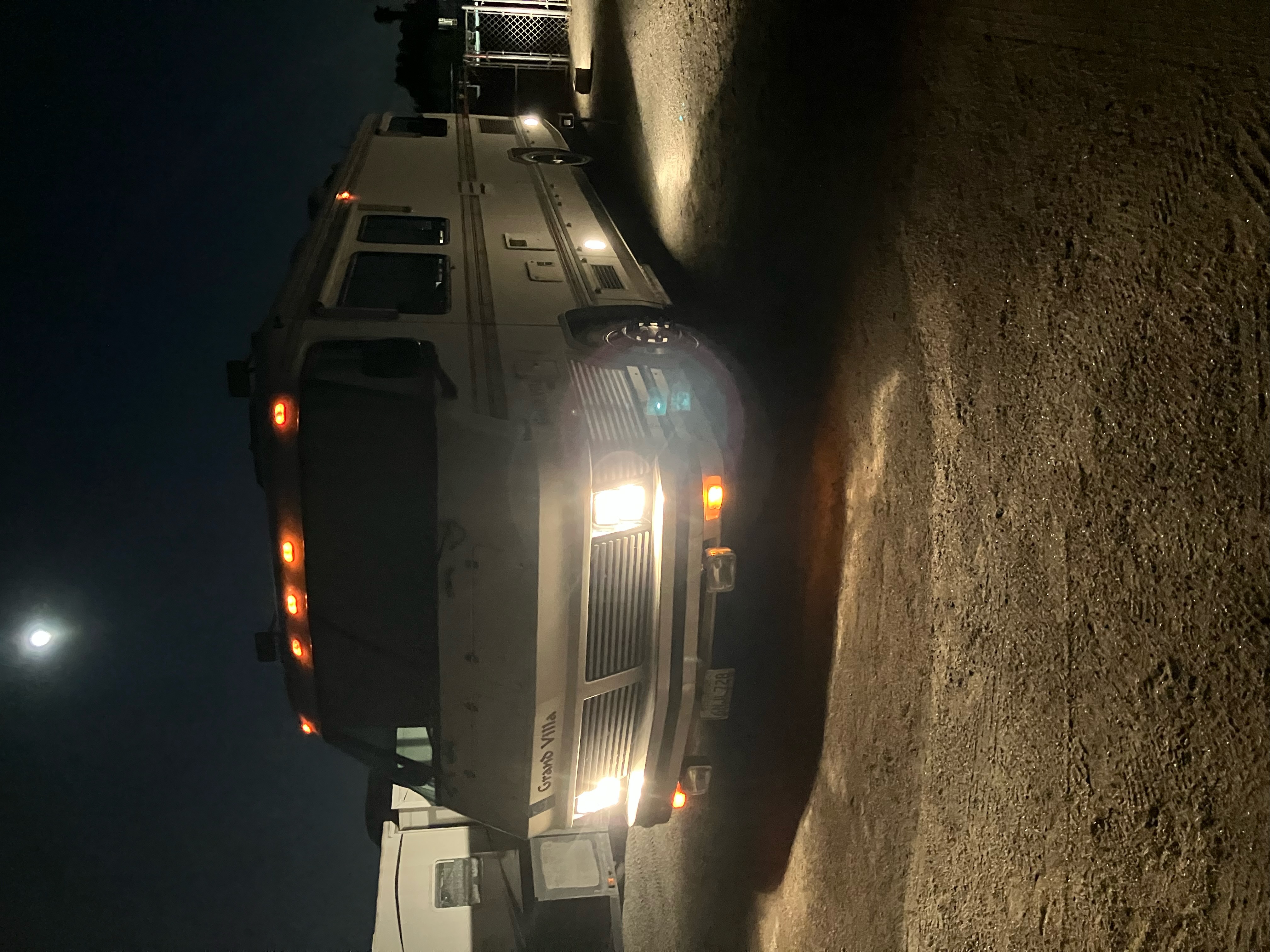 Exterior – front 3/4 (night, lights on)